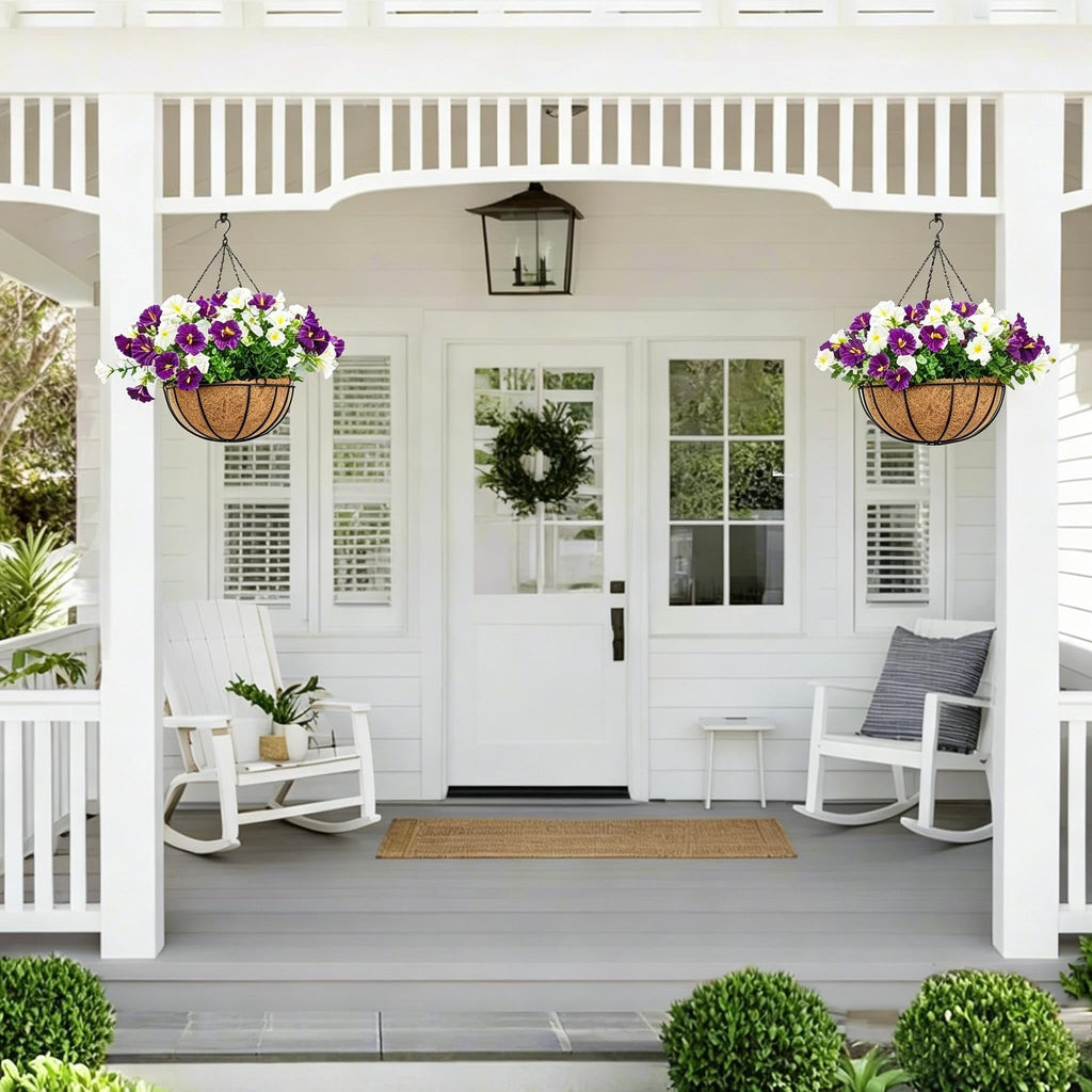 Pair of white and purple artificial hanging flower baskets decorating a front porch