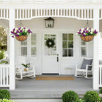 Pair of white and purple artificial hanging flower baskets decorating a front porch
