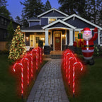 Red candy cane Christmas pathway lights lining a front yard walkway at night