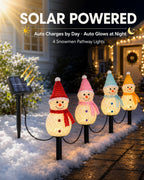 Solar powered snowman stake lights charging by day and glowing at night