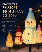 Close up snowman solar stake light with warm holiday glow
