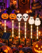 Halloween pumpkin skull and ghost solar stake lights in a front yard