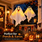 Two playful LED hanging ghosts decorating a front porch