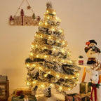 Gold ribbon fairy lights wrapped around a decorated Christmas tree