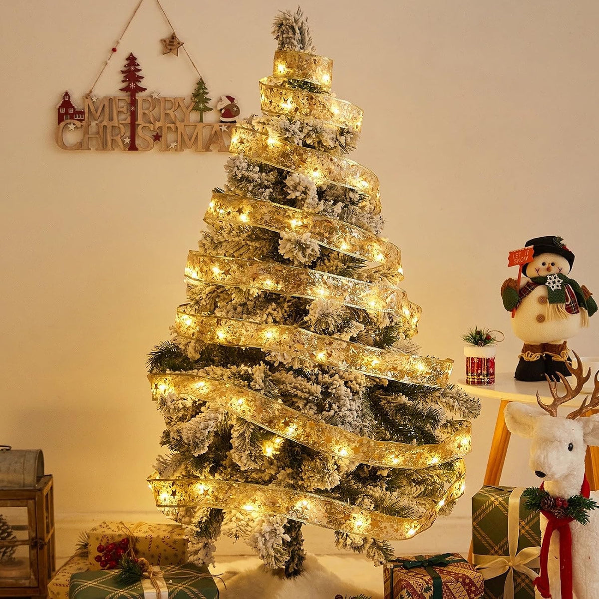 Gold ribbon fairy lights wrapped around a decorated Christmas tree